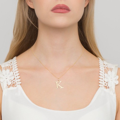 Złota zawieszka litera K z brylantem